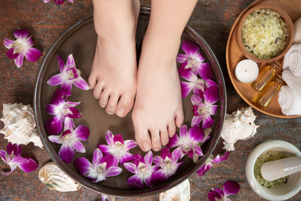 spa-treatment-product-female-feet-hand-spa-orchid-flowers-ceramic-bowl